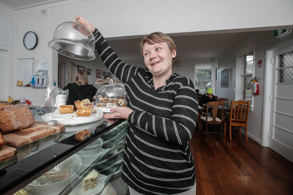 TOUGH TIMES: Cooinda participant Fleur Allan shows off some of the food she helped make for The Little Acorn Cafe back in 2017, the popular cafe closed its doors on Tuesday. 
