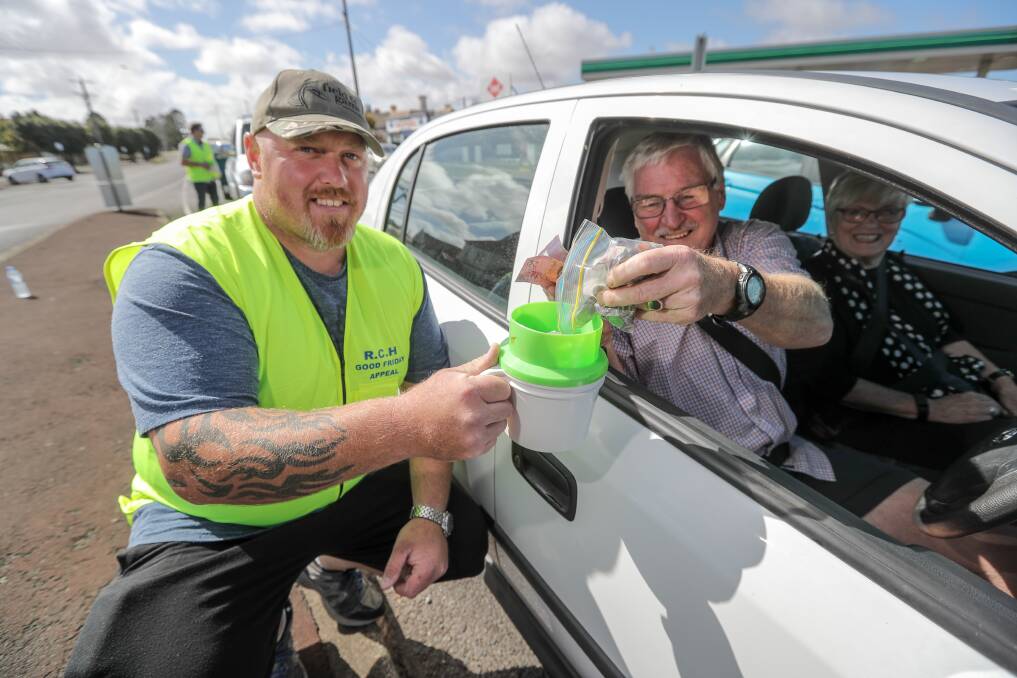 SUPPORT: Warrnambool's Justin Neave is happy to receive Bob Bowman's loose change collection during the Good Friday Appeal tin rattle on Raglan Parade in 2018, this year's appeal will be a virtual tin shake. 
