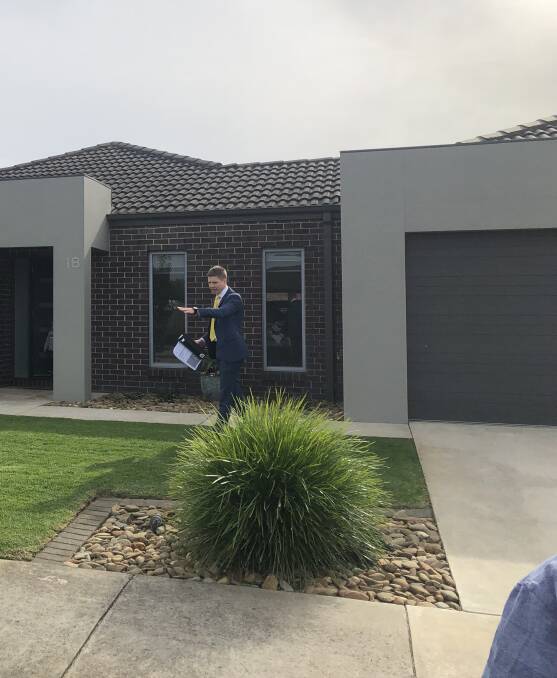 SOLD: Ray White auctioneer Fergus Torpy sells a house on Heazlewood Road in Warrnambool.