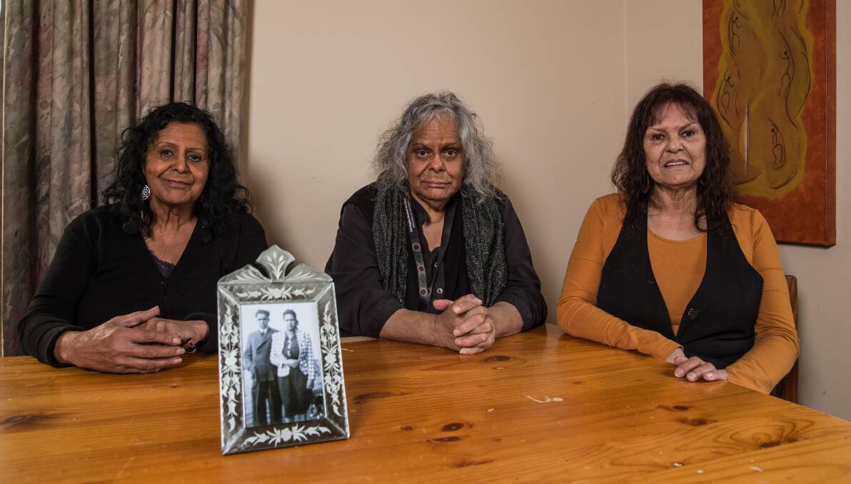 LEADING THE WAY: Sisters Patricia, Libby and Bernice Clarke with a photo of their parents Banjo and Audrey Clarke. Picture: Christine Ansorge