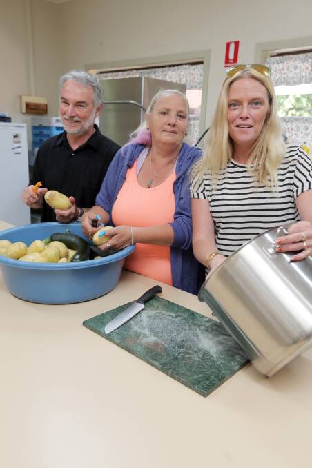 CLOSED: Uniting Church minister Geoff Barker and volunteers Rosemary Summers and Kristieanne Kelp get ready to feed the community at the church's weekly lunch in happier times. The lunch has been cancelled due to Coronavirus.