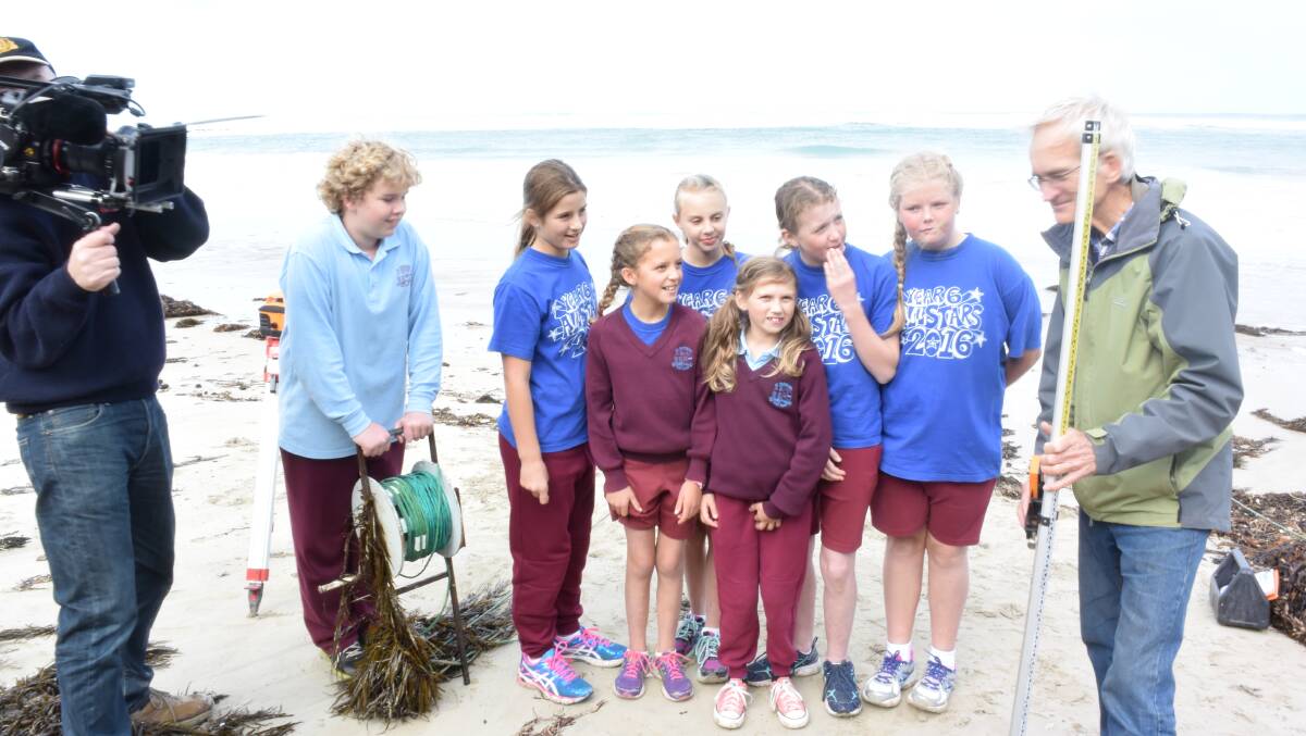 Stars: St Patrick's Primary School Port Fairy pupils (back l-r) Thomas Smith, Bree Fox, Avie Wanliss, Charlotte Dyson, Charlotte Watts, (front l-r) Lily Jol and Ruby Conlan with Port Fairy Coastal Group chairman Nick Abbott. Filming by Portland's Powerhouse Productions. Picture: Madeleine McNeil