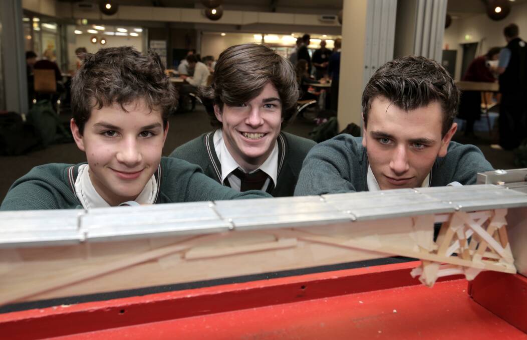 Fun: Brauer College's Kyle Bartlett, Ethan Moore and Lachlan Tripp, check their bridge design at an earlier Great South Coast Science and Engineering Challenge. This year's event will be held in Warrnambool at Deakin University on Tuesday. Picture: Rob Gunstone