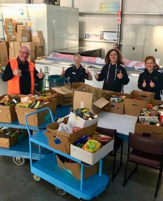 Community: Warrnambool and District Food Share chief Dedy Friebe with some of the Koroit and District Primary School students who donated more than 285 kilograms of groceries to the charity organisation.