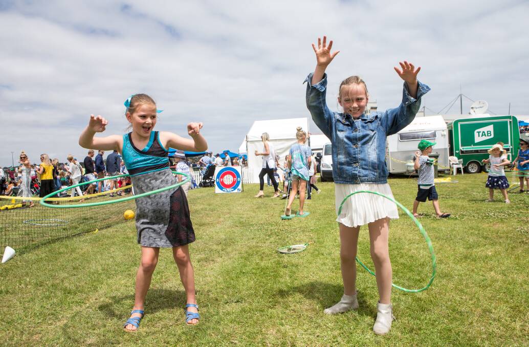 Family fun: The Woodford Cup New Year's Eve meeting attracted more than 5000 adults and 1000 children, including Lila Kenny, 8, and Eliza Watson, 8. Picture: Christine Ansorge