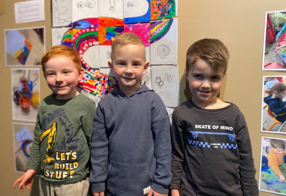 Warrnambool East Kindergarten children Fergus Mahney, Hudson Dillon and Levi Hill, all 4, at the Indigenous art and language exhibition. Picture: Madeleine McNeil