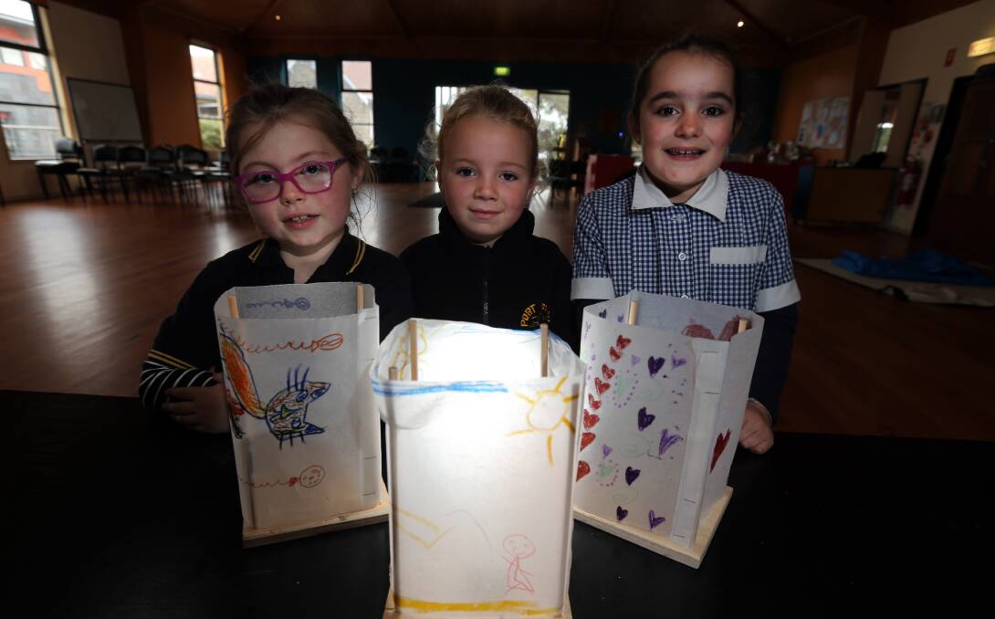 Lanterns: Port Fairy Consolidated School students Maddie Grayland, 7, Lexie Dwyer and Lucy Sanderson, both 6. Picture: Rob Gunstone