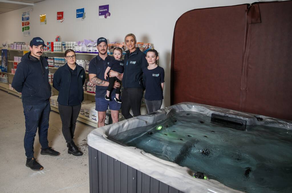 Excited: Crystal Water Pool n Spa team members Jimmy Elford, Montana Muldoon, Brandon Finn, Huxley Finn, 1, Emily Freeman and Sienna Keane, 7, with the spa that can be won as part of a competition with fellow Warrnambool businesses. It will be drawn at the Hampden Football Netball League grand final. Picture: Morgan Hancock 