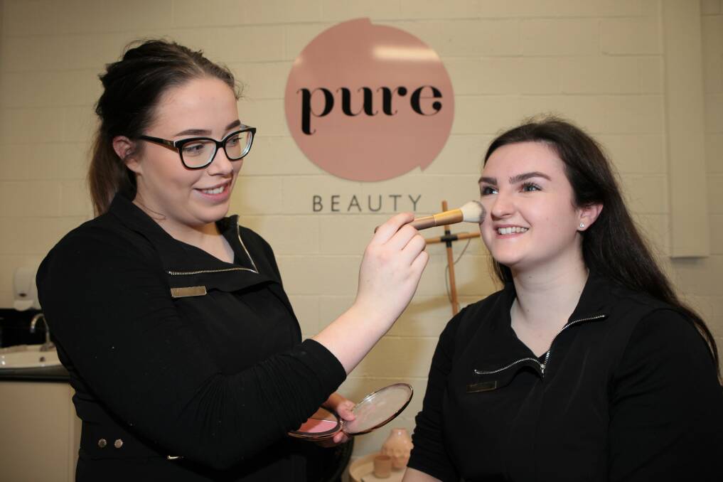 Hard at work: South West TAFE Diploma of Beauty students Katrina Irving and Brianna Butler. Pure Academy is a finalist in a national competition. Picture: Anthony Brady