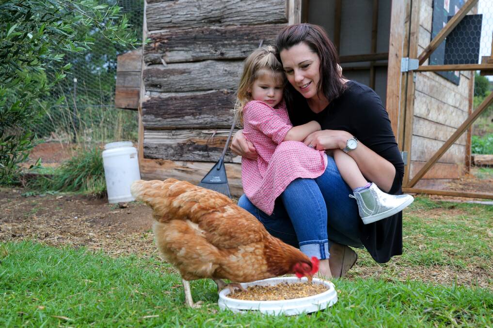 Sustainable: Warrnambool Community Garden workshop and event co-ordinator Hannah Chisholm and daughter Luca, 3, with Honey the chicken. Picture: Rob Gunstone