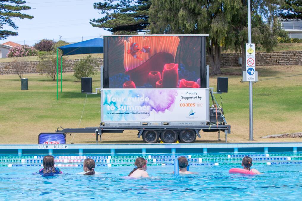 School holiday fun: Swimmers line the pool to watch Finding Nemo while having a swim themselves. The next dive-in movie will be screened on Wednesday, January 16 at 2pm. 
