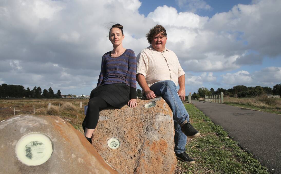 Rock on: Artists Becky Nevin, from Warrnambool, and Jon Dixon, from Lyons Sculpture Park, with an artwork they created on the Port Fairy to Warrmambool Rail Trail, to honour the town's history. Picture: Rob Gunstone