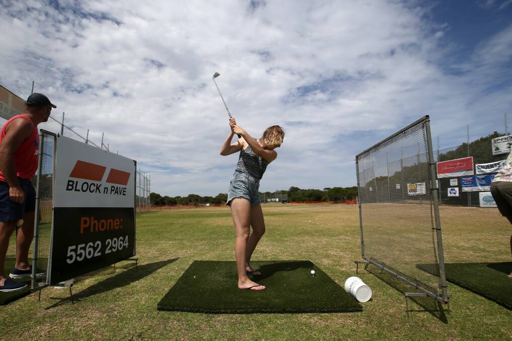 Hole in one a hit: Warrnambool's Gaby Carty powers through a bucket of golf balls at the Rotary Hole in One competition earlier this year. Picture: Amy Paton