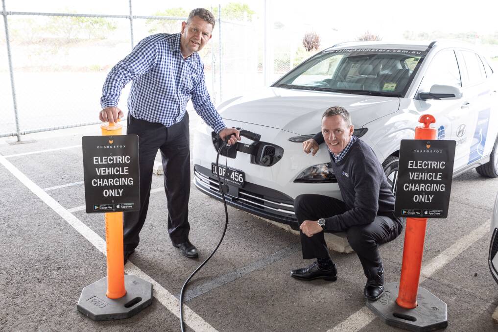 Callaghan Motors dealer principal Steve Callaghan with Shane Hicks at the dealership's electric car charging points. Electric vehicles are coming down in price as more manufacturers release them. Picture: Anthony Brady