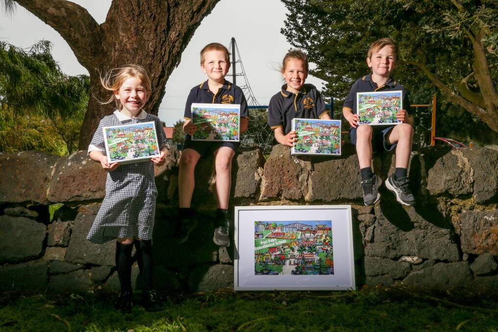 Proud: Port Fairy Consolidated School students Mia Jarrett, 5, Jack Neate, 6, Delilah Brennan, 6, and Angus Haldane, 6, showcase puzzles that feature the historic bluestone building, its Lone Pine and other work by Karen McKenzie. Pictures: Chris Doheny