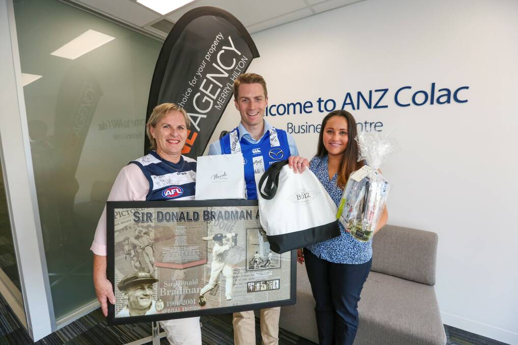 Success: One Agency's Merryl Hilton, left, with ANZ's Dale Camm and Alana Pittard prior to a fire relief auction which was held on Saturday. Picture: Tammy Brown