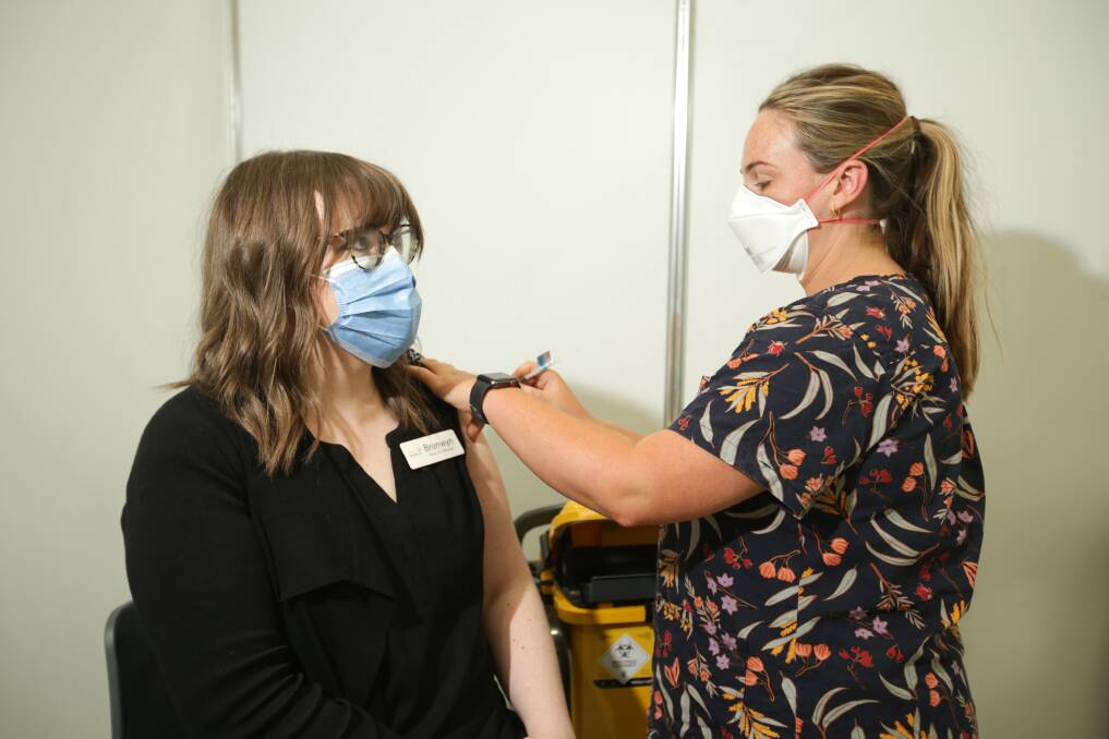 Protected: Nurse Penny Warner gives South West Healthcare nurse unit manager Bronwyn Davis her COVID-19 booster shot at the Warrnambool Vaccination Clinic. Picture: Chris Doheny