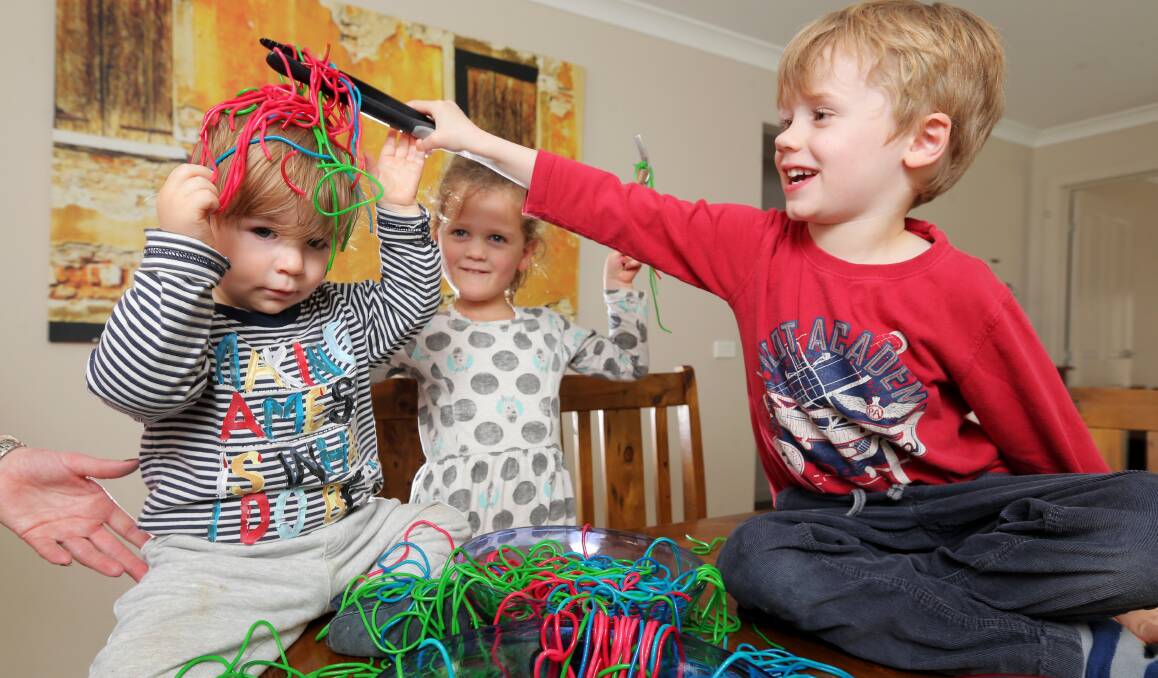 Hands on: Humphrey Horwill, 15 months, Violet Brennan, 5, and Felix Horwill, 5, prepare for the Messy Play Day on Sunday. Picture: Rob Gunstone