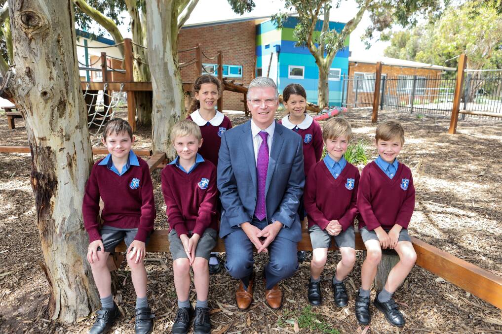 King's College principal Allister Rouse with twins Harry and Mason May, Evelyn and Jemimah Mehanni and Alexander and Benjamin Gristede who are all in the same year 2 class. The college is celebrating a jump in its enrolments, recording a 25 per cent growth in student numbers for 2023. Picture by Anthony Brady