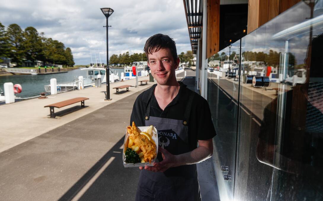 Fresh: The Wharf's Sean Malady with some of the takeaway offerings from the fish and chip shop which opened on Saturday. Picture: Morgan Hancock