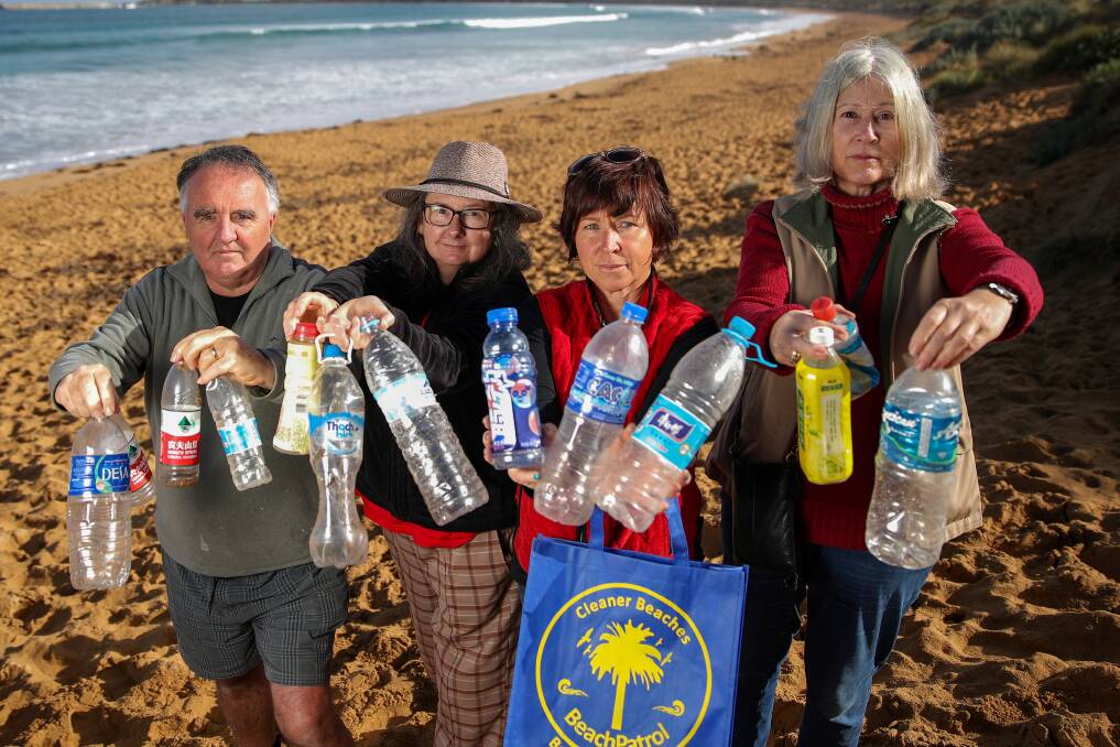 Found: Beach Patrol 3280-3284 volunteers Phil Benbow, Joanne Russell, Colleen Hughson and Mandy Shute with some of the foreign bottles that have washed up onshore. Picture: Morgan Hancock