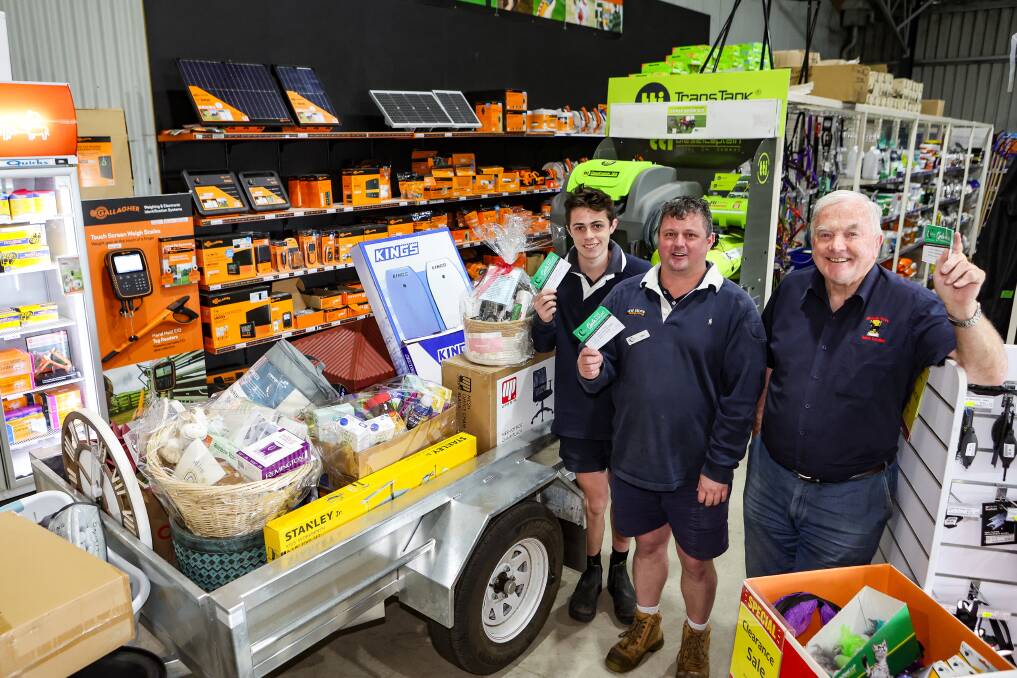 Terang Co-Op's Lincon Baker and John Meade with Terang & District Progress Association's Des McKinnon with a trailer of goods to be raffled at the town's annual gala night on December 22, 2023. Picture by Anthony Brady