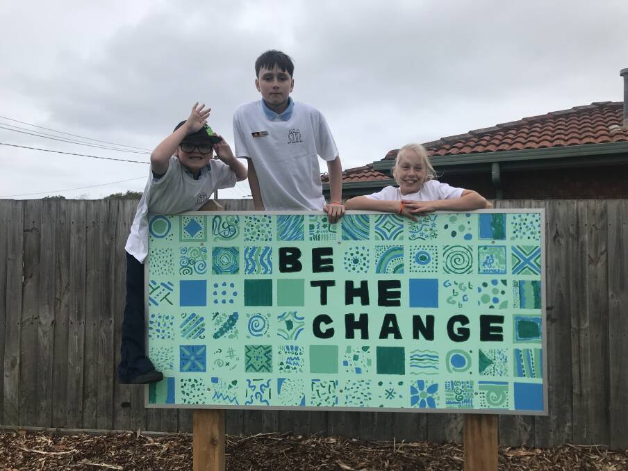 Constant reminder: WEPS community crew members Dylan Smith, 7, Jack Claridge and Mia Quarrell, both 12, with one of the art works that the students made. 


 
