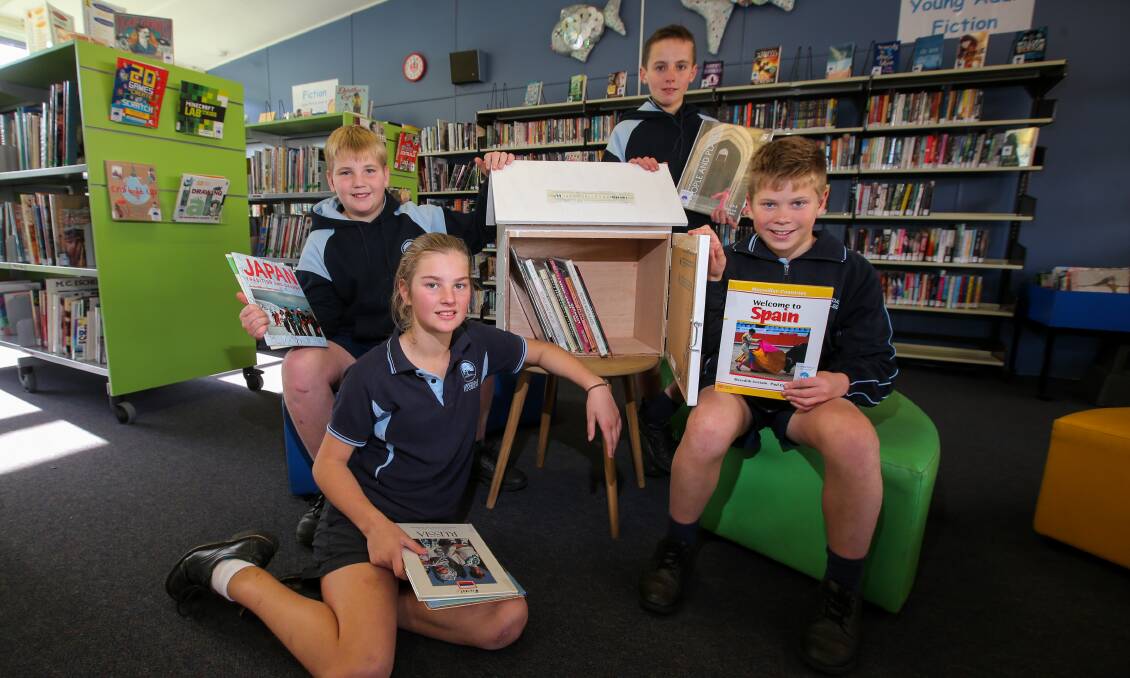 Rest and relax: Hawkesdale P-12 College year six students Noah Cameron, 11, Jordan Lang, 12, Tom Morisson, 12, and Max Hausler, 11, with the street library they will place in Apex Park, for the public to use. 