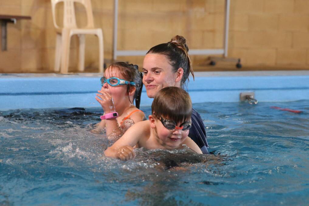 Vital skill: Swim school owner Jayson Lamb said participants' skills had declined, due to the stop-start nature of lockdowns. Pictured is Elisha Sobey with children Ivy, 6, and Regi, 4, when Jayson Lambs Splash Factory when indoor pools re-opened in November 2020. 