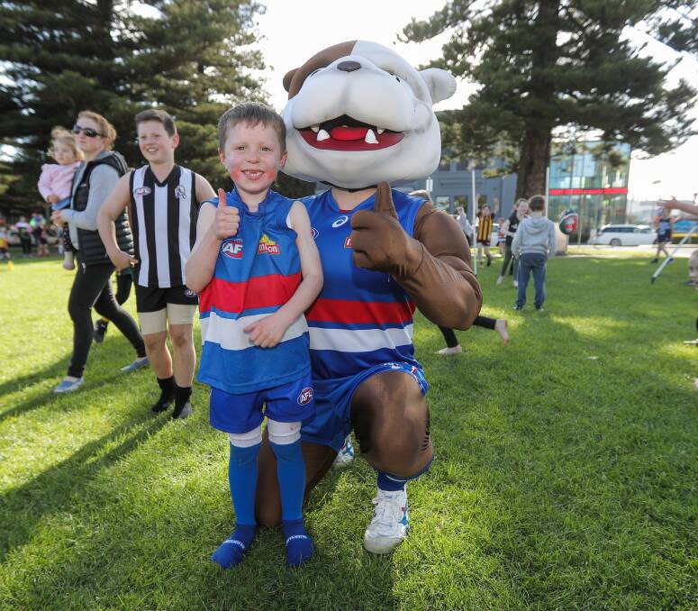Proud: Lewis Haberfield, 7, pictured with Woofer, the Western Bulldogs' mascot. Sally McConnell, of Warrnambool, was the lucky winner of the AFL Grand Final package for two people which was drawn as part of the day's festivities.