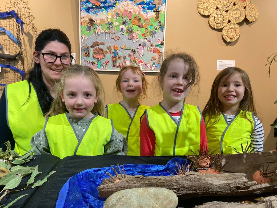 Artists: Florence Collins Kindergarten team leader Amber McFadyn and children Sophie O'Keeffe, 4, Evie Colgate, 5, Aurora Chamers-Simpson, 5, Deja, Brigham, 4, at the Indigenous art and language exhibition at the Lighthouse Theatre. Picture: Madeleine McNeil