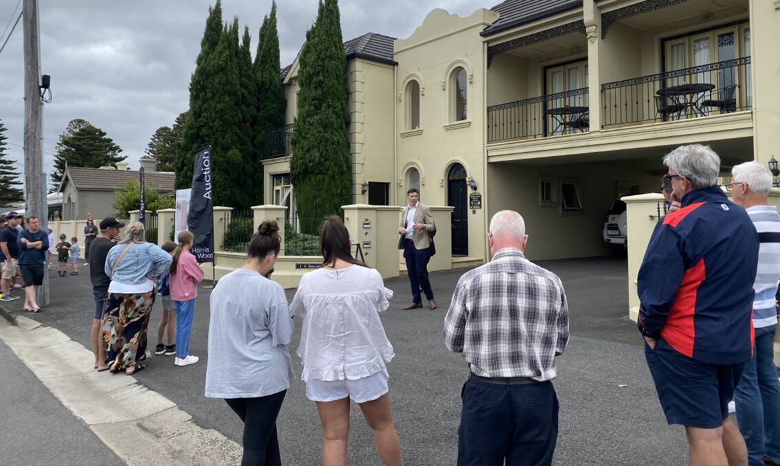About 40 people watched on as agent Danny Harris auctioned a two-bedroom townhouse in Warrnambool's Banyan Street on Saturday. It sold for $590,000. Picture by Madeleine McNeil