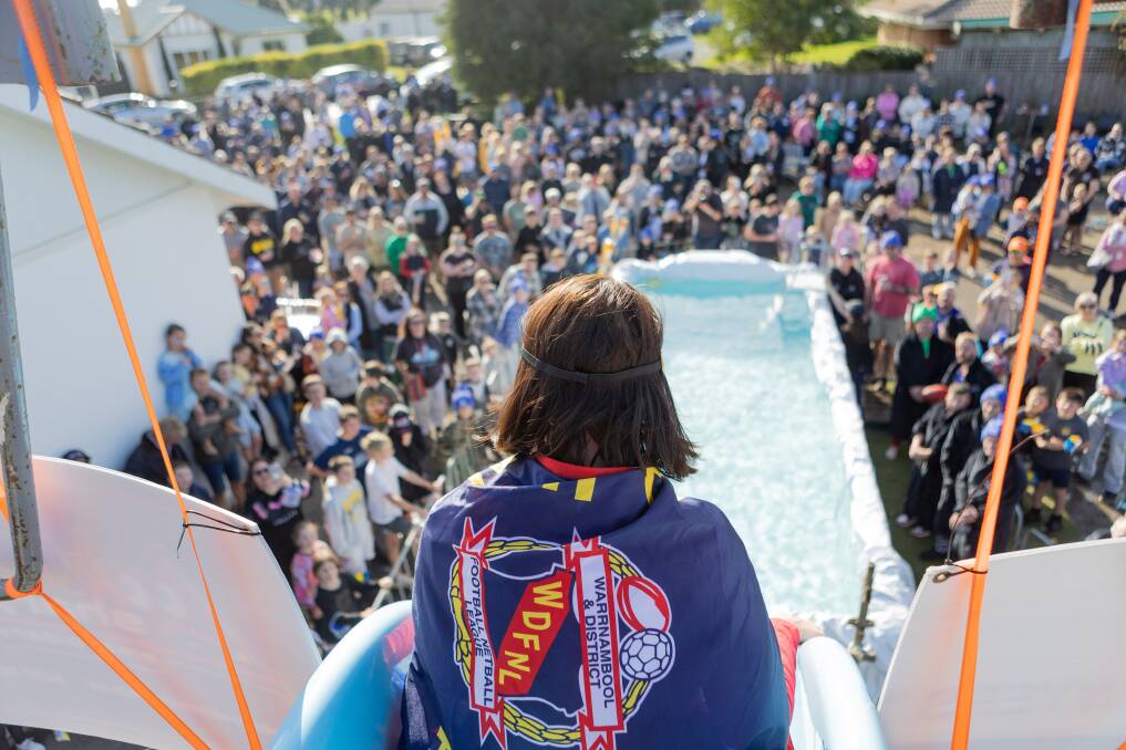 The crowd watches Stacy Mills ready to take on the South West Big Freeze slide at the Allansford Hotel on Sunday to raise money for Motor Neuron Disease. Picture by Anthony Brady