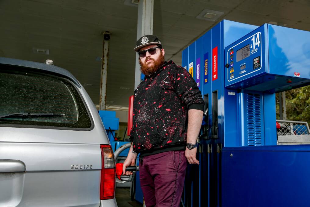 Necessity: Motorist Brady McKenzie fills up with petrol, despite the higher than usual fuel prices. Picture: Chris Doheny