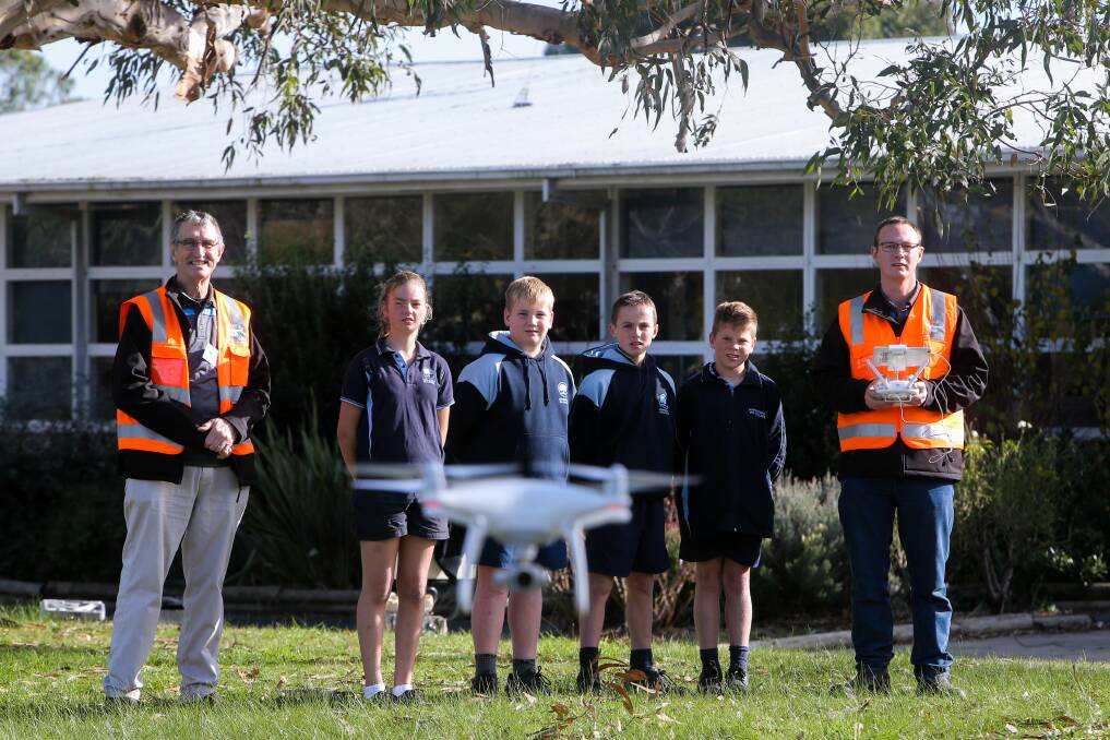 Flying high: Hawkesdale P-12 College students Jordan Lang, Noah Cameron, Tom Morrison and Max Hausler with Victorian Unmanned Aerial Systems Michael (left) and Matthew (right) Herbert. Picture: Rob Gunstone