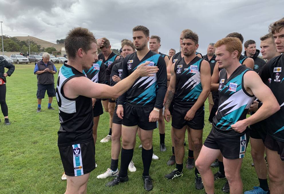 COACH'S TIPS: Kolora-Noorat coach Ben Walsh talks to his charges at quarter-time. 