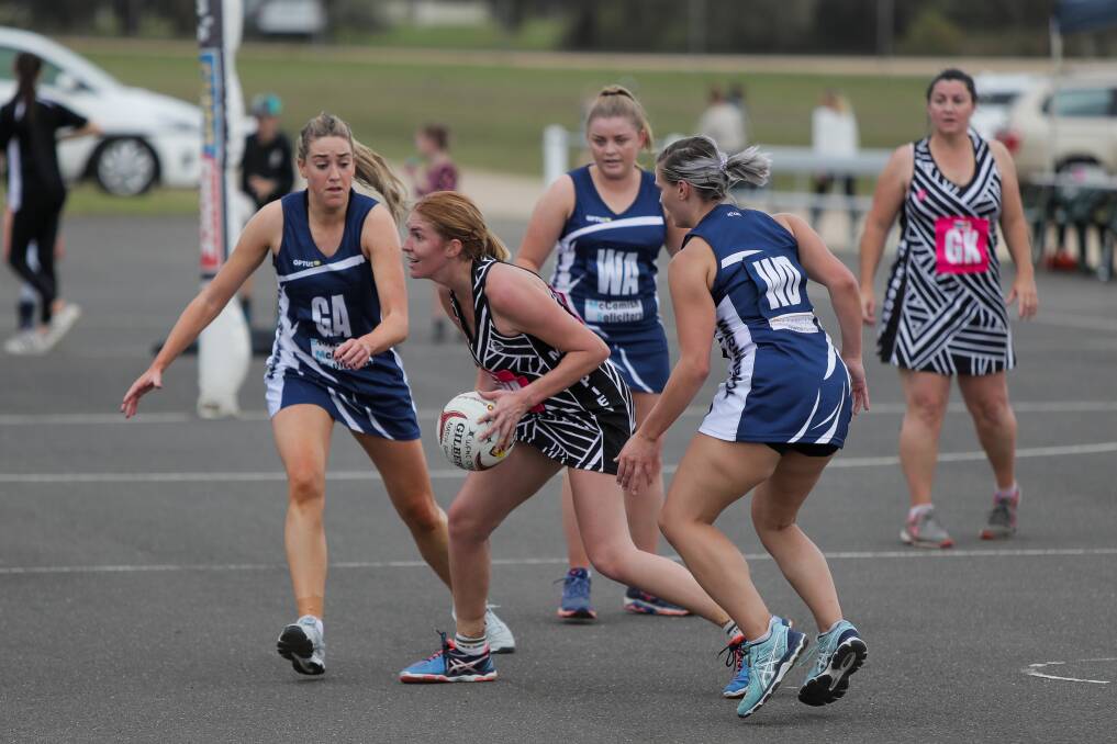 SURROUNDED: Camperdown recruit Amy Morssinkhof tries to pass as a Warrnambool trio closes in. Pictures: Morgan Hancock