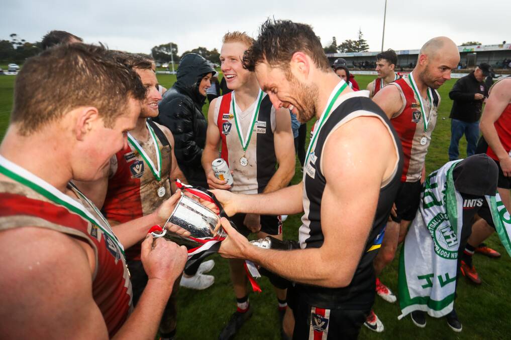 SMILE IF YOU'RE HAPPY: Sam Dobson with the Saints' latest piece of silverware. Picture: Morgan Hancock 