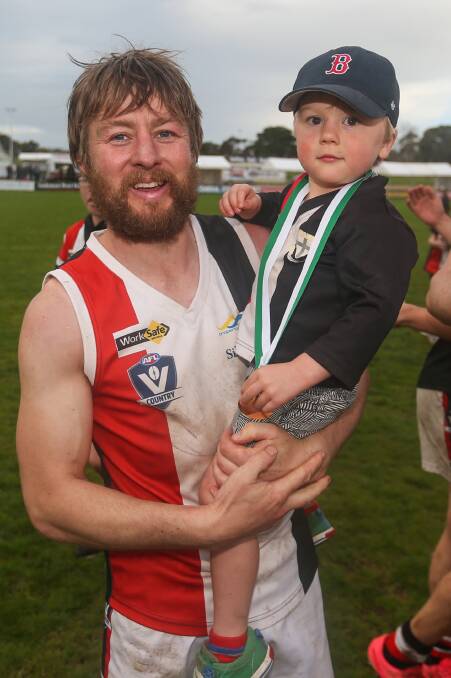 FAMILY TIME: Koroit veteran Ben Goodall, pictured with son Fred, is eager to play on in 2017 after winning his seventh Hampden flag. Picture: Morgan Hancock 