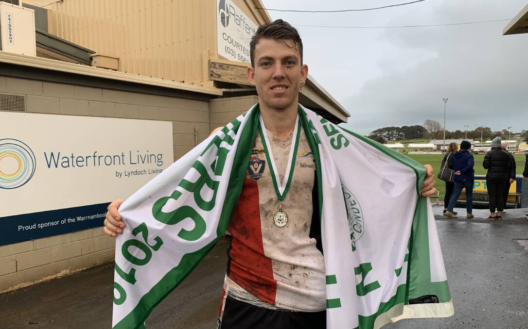COMEBACK COMPLETE: Jayden Watson with the 2019 Koroit premiership flag. Watson missed last season with a foot injury.