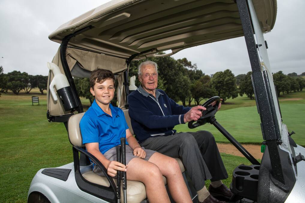 CHAUFFEUR: Allansford's Hugo Artz, 11, and Warrnambool's John 'Jack' Bullen, 97, are avid golfers. They're both members at Warrnambool. Picture: Christine Ansorge