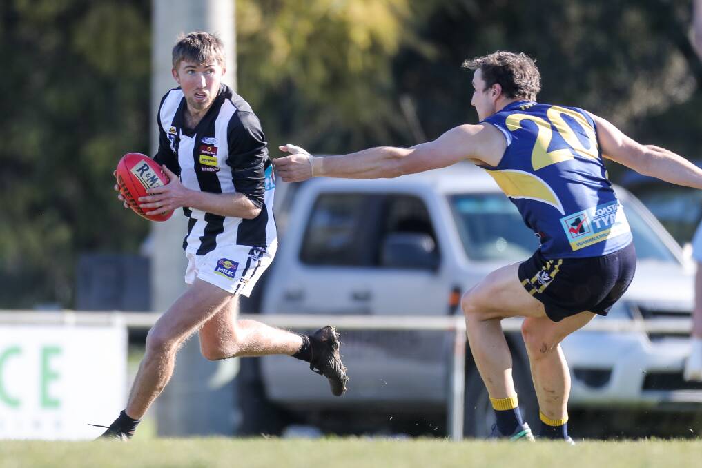 ROUND 12: Camperdown defender Brendan Richardson escapes Joe McKinnon's grasp in the Magpies' two-point win over North Warrnambool Eagles. Picture: Morgan Hancock