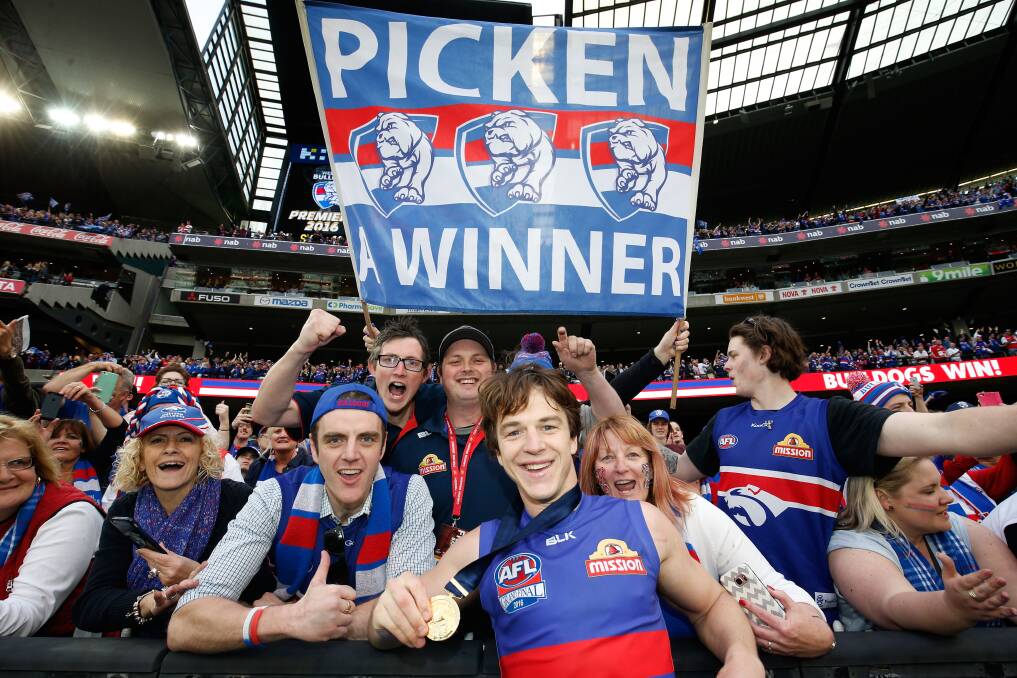 GRAND FINAL CHAMPION: Elated Western Bulldogs fans celebrate their drought-breaking premiership with Hamilton hero Liam Picken at the MCG on Saturday. Picture: Getty Images