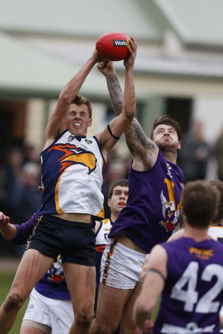 STRONG: Port Fairy's Guy Phelps tries to spoil a mark from North Warrnambool Eagles' Sam McLachlan on Saturday. Picture: Aaron Sawall