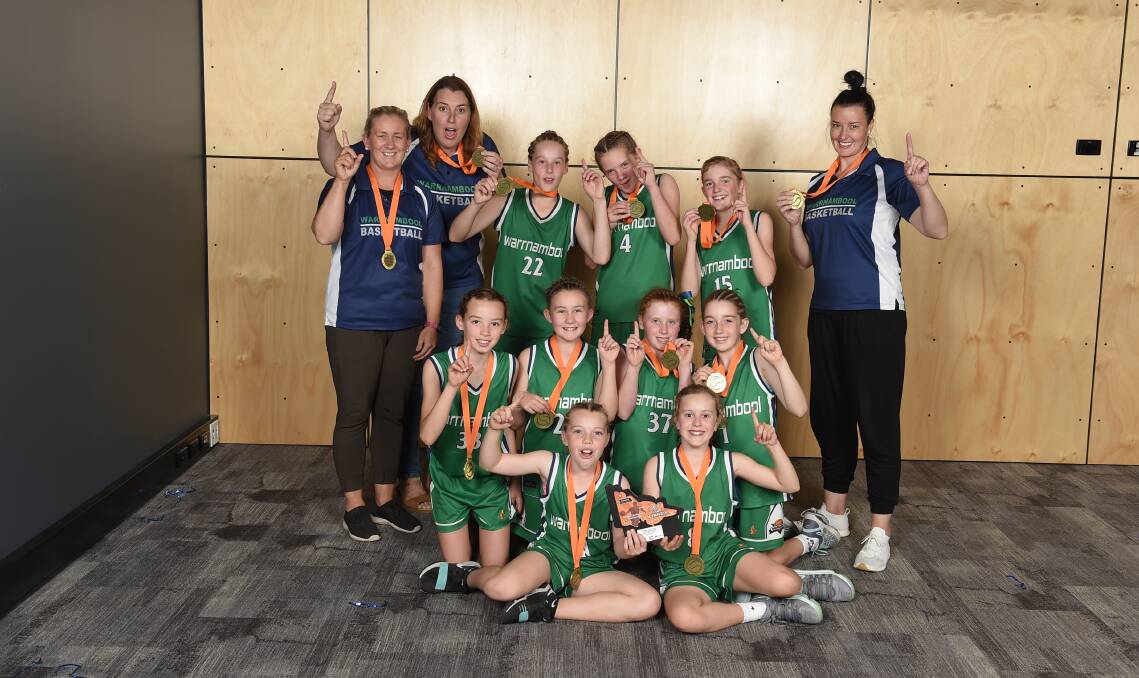 SMILE WHEN YOU'RE WINNING: Warrnambool Mermaids' under 12s celebrate their country championships success. Picture: Basketball Victoria