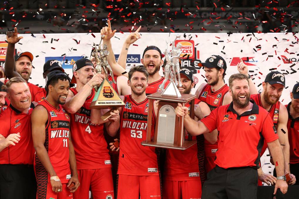 RED ARMY: Perth Wildcats coach Trevor Gleeson (right) celebrates with his 2018-19 NBL championship-winning team. Picture: AAP