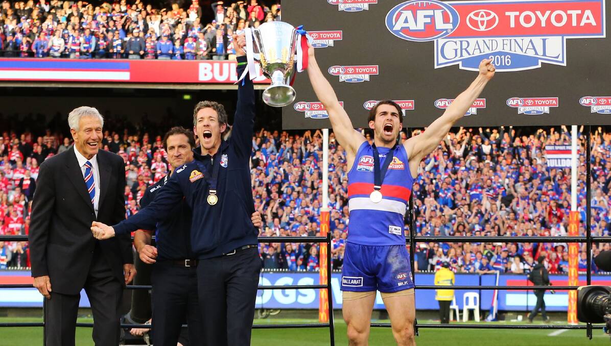 ICONIC: Bulldogs spiritual leader Bob Murphy and stand-in captain Easton Wood hold the 2016 premiership cup aloft. Pictures: Getty Images