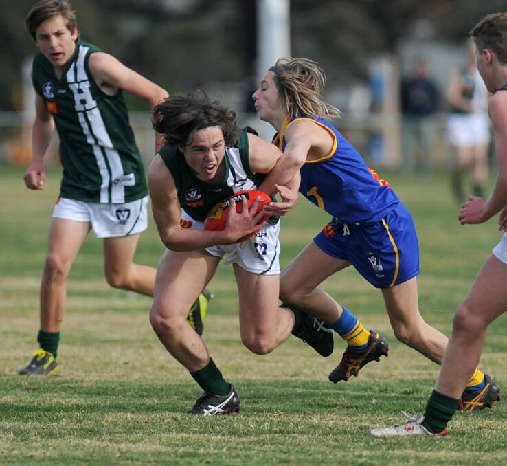 ALL WRAPPED UP: Hampden's Jackson Grundy is tackled by Wimmera's Matty Wynne in their under-15 schoolboys match in Ararat on Wednesday. Pictures: Samantha Camarri, Wimmera Mail-Times