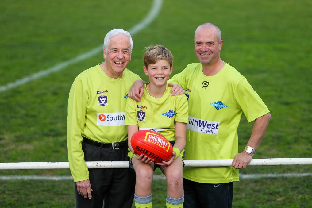 SAY CHEESE: Proud grandfather Daryl Pedler, 71, with grandson Campbell Pedler, 11, and son Nigel Pedler, 44. They will umpire together for the first time on Sunday. Picture: Morgan Hancock