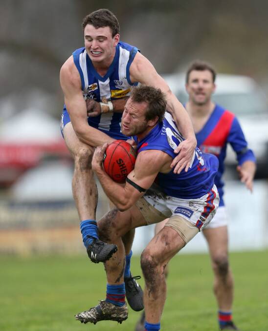 COLLISION: Hamilton Kangaroos' Kane Quinn crashes into Terang Mortlake's Joel Moloney. The Bloods fought back from 27 points down in the last quarter to win by two in a thriller. Picture: Amy Paton